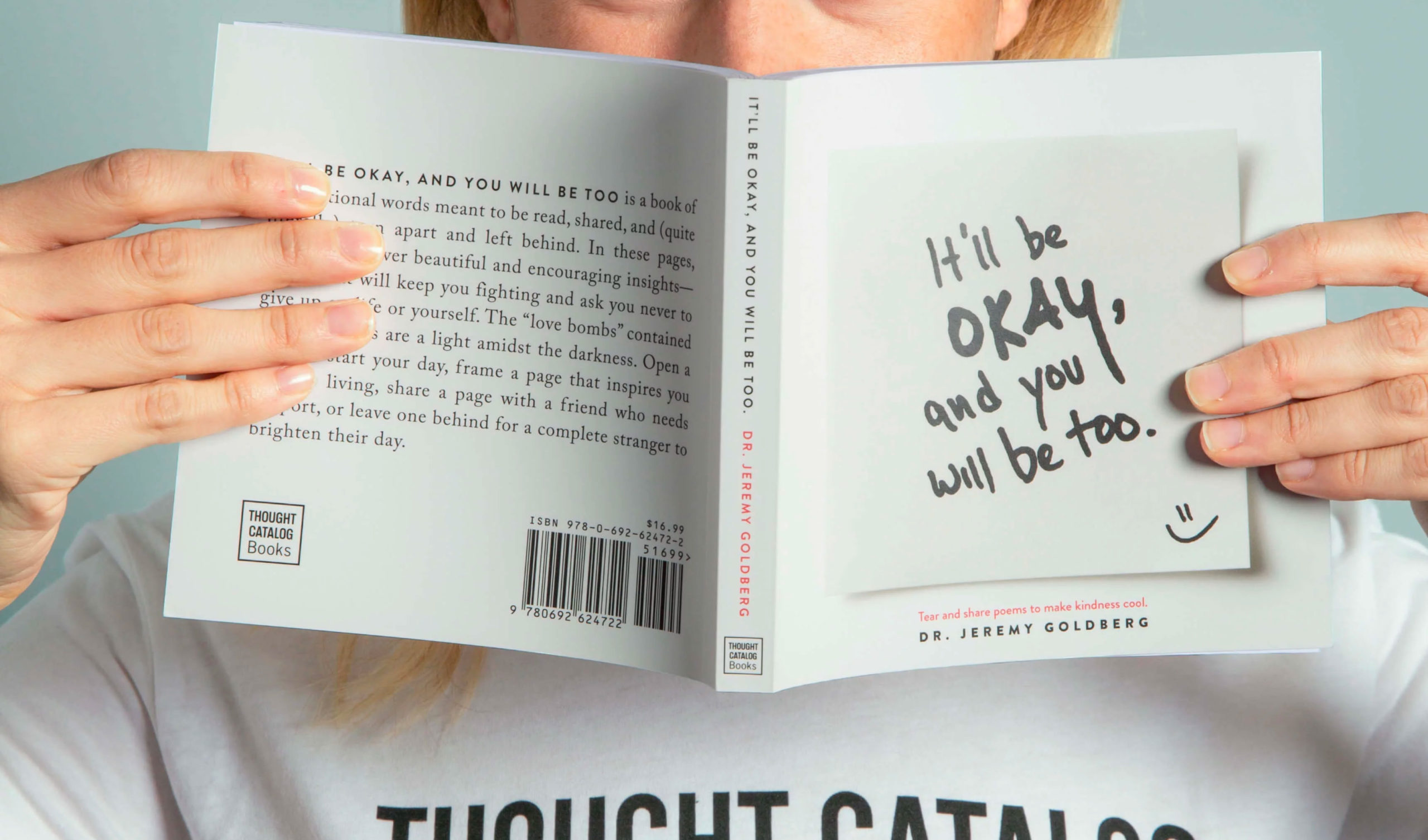 Person Holding a Book in Front of their Face Person Holding a Book in Front of their Face